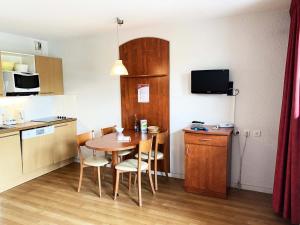 una cocina y una mesa en una habitación pequeña en Résidence Pic Du Midi - Studio pour 4 Personnes 714, en La Mongie