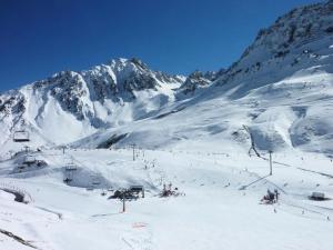 a snow covered mountain with a ski lift at Résidence Pic Du Midi - Apt n°9 - 1er Etage - Bâtiment Adour MAE-8714 in La Mongie +4 photos