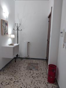 a hallway with a white room with a cross on the wall at Casa Lodi Casavacanze in Eboli +41 photos