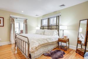 a bedroom with a bed and a mirror at Elegant Saratoga Springs Stay Walk to Town, Track in Saratoga Springs