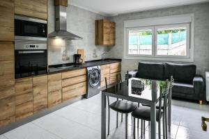 a kitchen with a table and a stove top oven at Apartamentos Costas de Bueu A in Bueu