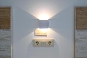 a light on a wall with a lightswitch at Apartamentos Costas de Bueu A in Bueu