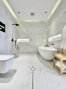 uma casa de banho branca com uma banheira e um lavatório em Sidra chalet 