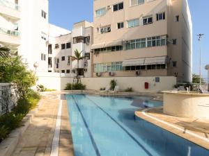 a swimming pool in front of a building at LINKHOUSE LUXURY BEACHFRONT FLATS in Rio de Janeiro