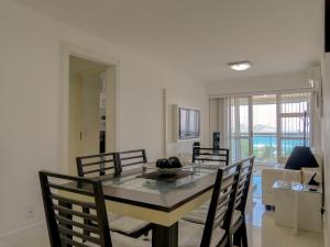- une salle à manger avec une table et quatre chaises dans l'établissement LINKHOUSE LUXURY BEACHFRONT FLATS, à Rio de Janeiro
