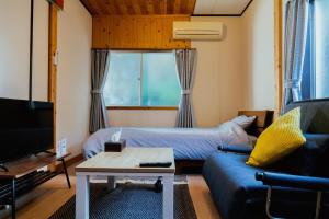 un soggiorno con divano e TV di Atami-Ajironokaze - Vacation STAY 87959v ad Atami