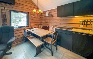 a wooden kitchen with a wooden table and chairs at Awesome Home In seral With Wifi in Åseral