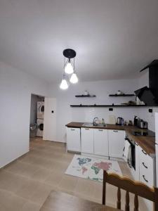 a kitchen with white cabinets and a counter top at White House Apartments in Haskovo