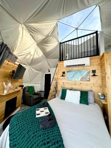 a bedroom with a bed in a tent at Island Beach Hideaways in Pomquet