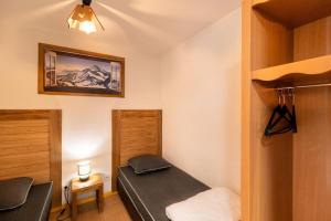 a small room with a bed and a closet at Résidence Le Parc Des Airelles - Studio pour 4 Personnes 684 in Les Orres