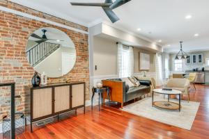 a living room with a brick wall and a mirror at Charming Baltimore Getaway about 1 Mi to Downtown! in Baltimore