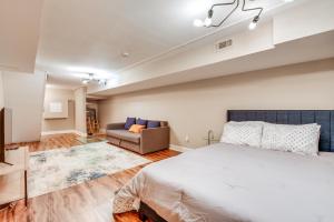 a bedroom with a large bed and a couch at Charming Baltimore Getaway about 1 Mi to Downtown! in Baltimore
