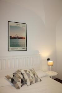 a bedroom with a bed and a picture on the wall at Stefano's Apartment in Bari