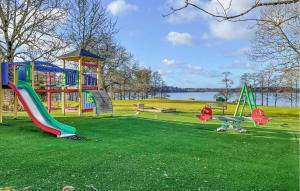 a park with a playground with a slide and an airplane at Lovely Home In Lnghem With Kitchen in Länghem