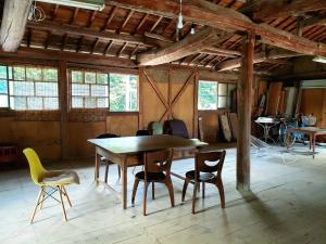 a dining room with a table and chairs at Guesthouse Tao in Tanabe