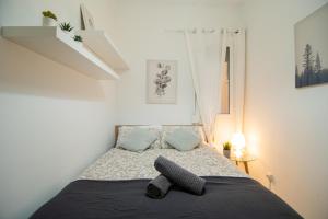 a small bedroom with a bed with a black blanket at Blai in Barcelona
