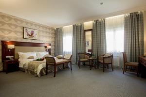 pokój hotelowy z łóżkiem, stołem i krzesłami w obiekcie Hotel SKY CENTR Krasnoyarsk w Krasnojarsku