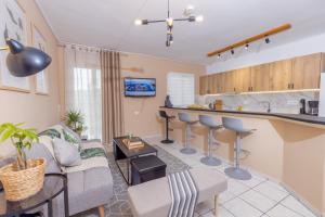 a living room with a couch and a kitchen at Sarita's Apartments & Suite in Laganas