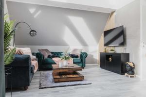 a living room with two couches and a tv at Luxury 4 Bedroom Apartment/Therme Erding/Parking in Erding