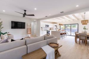 a living room with a couch and a table at Modern Beach Home, Family Friendly, Heated Pool in West Palm Beach