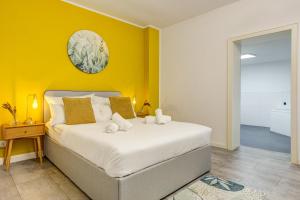 a bedroom with a bed with a yellow wall at Zentrale Design Wohnung in Ufernähe - 105 qm - Parkplatz - Küche - Netflix in Bingen am Rhein