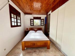 a bedroom with a bed in the corner of a room at VILLA DES PALMIERS in Le Marin