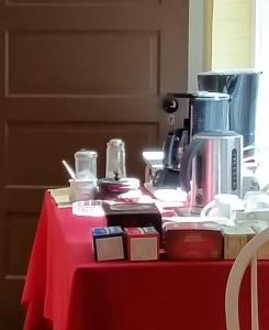 a table with a red table cloth with a coffee maker on it at Mountain Home Bed & Breakfast in Front Royal +30 photos
