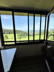 a room with a window with a table and a view at Résidence Les Glovettes - Studio pour 4 Personnes 954 in Villard-de-Lans