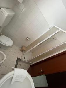 a bathroom with a white toilet and a sink at La Casa Dei Sogni in Gallico