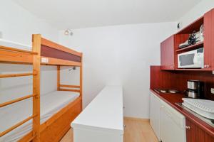 a kitchen with a bunk bed and a microwave at Résidence Les Balcons de Collioure - maeva Home - Studio 4 Personnes Confort MAE-5972 in Collioure +6 photos