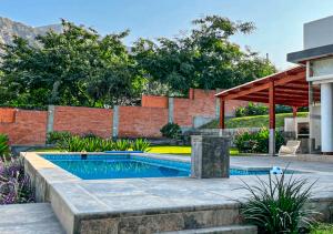 a swimming pool in the middle of a yard at KUSI WASI CIENEGUILLA in Cieneguilla