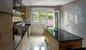 a kitchen with a counter and a window at Apartamentos Costas de Bueu in Bueu
