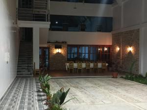 a courtyard of a house with a table and chairs at Estancia Entre Las Nubes in Chachapoyas