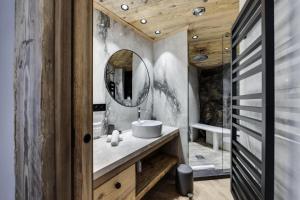 a bathroom with a sink and a mirror at Résidence Cahokia - Chalets pour 13 Personnes 464 in Val-d'Isère