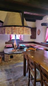 a kitchen with a table and a stove in a room at Il tempio nel bosco The Rustic Rooms & Wine 