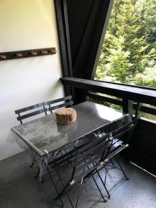 a table with a loaf of bread on it next to a window at Résidence Les Glovettes - Studio pour 5 Personnes 114 in Villard-de-Lans