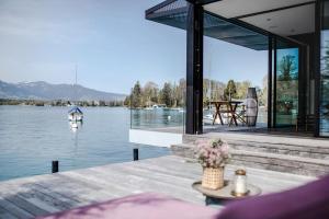 a house with a view of the water at Award-winning cottage on lake Thun- New in Thun