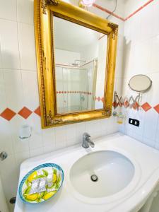 a bathroom with a sink and a mirror at Casa Pippo 2 in Anacapri