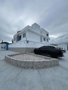 a black car parked in front of a house at Atena Flats in Aracaju