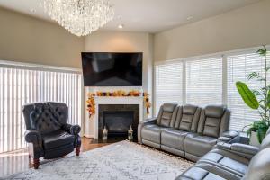 a living room with two leather chairs and a fireplace at Spacious Woodbridge Home Near Leesylvania Park! in Woodbridge