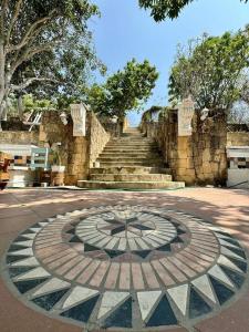 a large stone clock in the middle of a road at Villa Mohana in Puerto Colombia