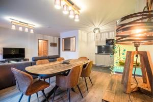 a living room with a wooden table and chairs at Résidence LUMI BATIMENT B - Appartement LUMI B pour 4 Personnes 014 in Valmorel