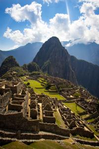 an ancient amphitheater with a mountain in the background at Rockrivers MachuPicchu in Machu Picchu