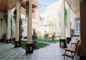 a courtyard with benches in a building at Alifa Lux Guesthouse in Samarkand