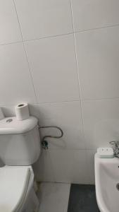 a white bathroom with a toilet and a sink at Logement calme très proche du centre in Oujda