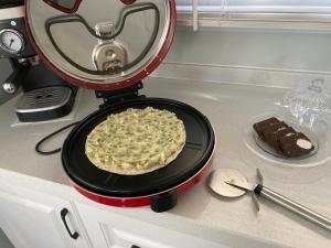 a pancake being cooked in a pancake maker on a counter at Stephanie’s Country Cottages in Drummond