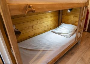 an empty bunk bed in a wooden room at Résidence Les Ecrins - Studio pour 4 Personnes 224 in Les Orres