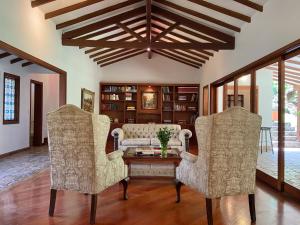 uma sala de estar com duas cadeiras e uma mesa em Casa Chipre By Wynwood House em Medellín