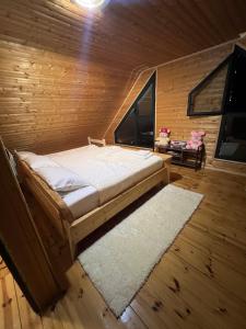 a bedroom with a bed in a wooden room at Vila Tea Durmitor in Žabljak