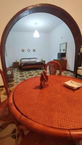 a room with a table and a bed in the background at Casa Di Mitri in Carini +22 photos